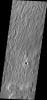 This image from NASA's Mars Odyssey shows an interesting surface texture located in Elysium Planitia on Mars. The upper layer appears to have a linear pattern eroded into the material.