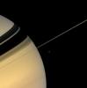 The serene beauty of Saturn invites NASA's Cassini spacecraft's gaze as the spacecraft hurtles through this dynamic system, studying the giant planet's rings, moons, atmosphere, and magnetosphere.