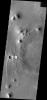 This image from NASA's Mars Odyssey shows ejecta pattern and double crater indicate that two impactors on Mars hit at the same time. The ejecta pattern and doublet crater look like a fancy butterfly flying west.