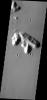 This image from NASA's Mars Odyssey shows dark slope streaks prevalent on these isolated hills near the Tartarus Montes on Mars.