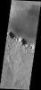 This image from NASA's Mars Odyssey shows small dark dunes located on the floor of an unnamed crater in Tyrrhena Terra.