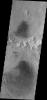 This image from NASA's Mars Odyssey shows the northern part of Du Martheray Crater and the smaller crater on its rim. Both craters have floor features showing evidence of both wind erosion and wind deposition.