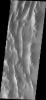 This image from NASA's Mars Odyssey shows a small portion of the Lycus Sulci region that surrounds Olympus Mons on its north and western flanks. The ridges of the Sulci host numerous dark slope streaks.