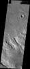 This image from NASA's Mars Odyssey shows numerous small, bright dunes in the channels of southern Thaumasia Planum.