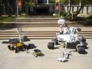 Full-scale models of three generations of NASA Mars rovers show the increase in size from the Sojourner rover of the Mars Pathfinder project, to the twin Mars Exploration Rovers Spirit and Opportunity, to the Mars Science Laboratory rover.