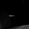 NASA's Cassini spacecraft looks to the night side of Saturn and its rings for a view that includes Dione. Tiny Pandora is also present outside the F ring in this image taken on Sept. 22, 2009.