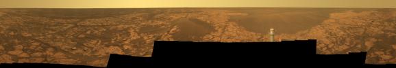 This image from NASA's Mars Exploration Rover Opportunity shows lighter-toned patches of ground ofsulfate-rich bedrock. Darker patches are dark, windblown sand. The metal post in the foreground is the top of Opportunity's low-gain antenna.