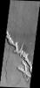 This 2001 Mars Odyssey spacecraft image shows a channel on Mars with extensive scalloping of its margins. The process of scalloping is widening the channel.