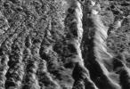 This perspective view, generated from high resolution images acquired by NASA's Cassini orbiter, highlights one of the wall scarps of the medial trough of Damascus Sulcus on Enceladus.