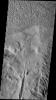 This image from NASA's Mars Odyssey shows several features found in Lycus Sulci on Mars including tectonic derived ridges (bottom of frame) with dark slope streaks and extensive wind etching and erosion of materials (top of frame).