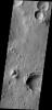 NASA's 2001 Mars Odyssey spacecraft captured numerous dark slope streaks in this small unnamed crater in Zephyria Planum.