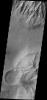 Spurs and gullies form the cliff sides of the Vallis Marineris chasmata at top of this image captured by NASA's 2001 Mars Odyssey spacecraft. Sand dunes at the bottom of image are a common feature on the floors of the chasmata.