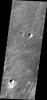 This image from NASA's Mars Odyssey of part of Meridiani Planum contains windstreaks that formed in several directions around a single crater. This indicates that wind directions changed, forming new tails for each prevailing wind direction.