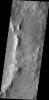 This image from NASA's Mars Odyssey shows dark slope streaks, a common feature on the rim of this unnamed crater within Tikhonravov Crater.