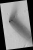 Two dark, rimless pits are located to the northwest of Ascraeus Mons in the Tharsis volcanic region of Mars in this image from NASA's Mars Reconnaissance Orbiter. They are situated in the midst of a wispy, dark, boomerang-shaped deposit.
