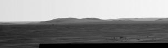 Rising highest above the horizon in the right half of the image, captured by NASA's Mars Exporation Rover, is a portion of the western rim of Endeavour Crater including a ridge informally named 'Cape Tribulation.'