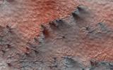 This terrain, as seen by NASA's Mars Reconnaissance Orbiter, looks like lumpy sediment on top of patterned ground. The lumpy sediment is likely just loosely consolidated because it is covered with spidery channels.