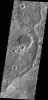 An unnamed channel drains a high standing region in Tyrrhena Terra in this image captured by NASA's 2001 Mars Odyssey spacecraft.