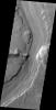 This image captured by NASA's 2001 Mars Odyssey spacecraft shows Reull Vallis where it cuts through the rim of Lipik Crater.