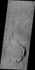 Only part of the rim of an unnamed crater remains visible above the lava flows in this region of Tharsis. This image is from NASA's 2001 Mars Odyssey spacecraft.