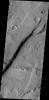 The cliff face in this image from NASA's 2001 Mars Odyssey spacecraft was created by tectonic activity and is located in a region of Tempe Terra that is complexly fractured.