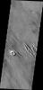 The wind eroded material in this image from NASA's 2001 Mars Odyssey spacecraft are located just north of Amazonis Mensa.