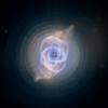 This detailed view of NGC 6543, the Cat's Eye Nebula, from NASA's Hubble Space Telescope includes intricate structures, including concentric gas shells, jets of high-speed gas, and unusual shock-induced knots of gas.