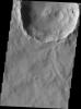 Dark slope streaks mark the rim of this unnamed crater near Schiaparelli Crater as seen by NASA's 2001 Mars Odyssey spacecraft.
