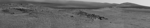 NASA's Opportunity used its Pancam to record this view of the rise in the foreground, called 'Nobbys Head.' This view is centered toward the south-southeast, with Opportunity's next destination, 'Solander Point,' toward the right edge of the view.