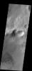 This image of Baltisk Crater shows a sand sheet on the crater floor and channels dissecting the outer rim as seen by NASA's 2001 Mars Odyssey spacecraft.