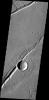 The fractures in this image captured by NASA's 2001 Mars Odyssey spacecraft are part of Labeatis Fossae. The large impact crater was formed after the fractures.