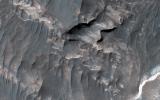 NASA's Mars Reconnaissance Orbiter shows light-toned deposits along Coprates Chasma slopes.