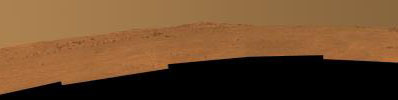 This view toward the south is a mosaic of images taken by Opportunity's Pancam on Dec. 25, 2013. The rover team plans to use Opportunity during 2014 to investigate rock layers exposed on the slope upward toward the McClure-Beverlin Escarpment.