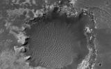NASA's Mars Reconnaissance Orbiter spies an impact crater located in northern Sinus Meridiani has formed along the boundary of two different terrain units.