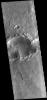This image from NASA's 2001 Mars Odyssey spacecraft shows a landslide deposit within a complex crater (note the ejecta to the top and bottom of the image). There is a smaller complex crater on the ejecta to the north of the larger crater.
