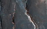 This observation from NASA's Mars Reconnaissance Orbiter shows an interesting crater floor with what appear to be inverted channels, rounded lobe-like landforms, and light-toned layered deposits along the southern portion of the crater wall.