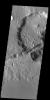 This image captured by NASA's 2001 Mars Odyssey spacecraft shows several linear depressions that cross an unnamed crater. The depressions are tectonic fractures that are hundreds of km long.