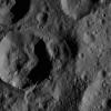 This image, taken by NASA's Dawn spacecraft, shows unnamed craters high in the northern hemisphere of Ceres. A bright patch of material can be seen on the upper wall of the large crater (near the lower left corner of the view).