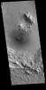 This image from NASA's 2001 Mars Odyssey spacecraft shows small, dark dunes located on the floor of this unnamed crater in Isidis Planitia.