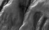 This image captured by NASA's Mars Reconnaissance Orbiter spacecraft was taken to look at seasonal frost in gullies during southern winter on Mars, with the Sun only about two degrees over the horizon (just before sunset).