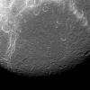 Dione reveals its past via contrasts in this view from NASA's Cassini spacecraft. The features visible here are a mixture of tectonics (bright, linear features and impact cratering) the round features, which are spread across the entire surface.