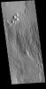 This image captured by NASA's 2001 Mars Odyssey spacecraft is located in a region that has been heavily modified by wind action.