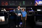Actor Chris Evans receives a boarding pass to the Moon from Suzanne Dodd, director of the Interplanetary Network Directorate at NASA's Jet Propulsion Laboratory. The pair are seen in the Space Flight Operations Facility at JPL on June 6, 2022.