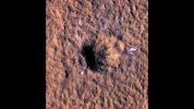 Boulder-size blocks of water ice can be seen around the rim of an impact crater on Mars. The crater was formed Dec. 24, 2021, by a meteoroid strike in the Amazonis Planitia region.