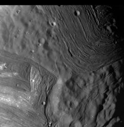 This image of Miranda, obtained by NASA's Voyager 2 on approach in 1986, shows an unusual 'chevron' figure and regions of distinctly differing terrain on the Uranian moon. 
