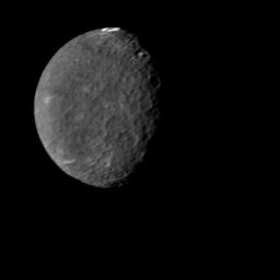 The southern hemisphere of Umbriel displays heavy cratering in this NASA Voyager 2 image, taken Jan. 24, 1986. This frame is the most detailed image of Umbriel, the darkest of Uranus' larger moons.