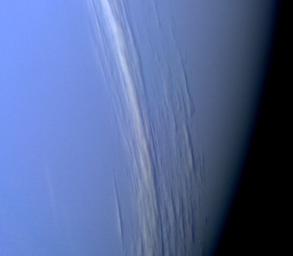 NASA's Voyager 2 captured this high resolution color image, taken 2 hours before closest approach, providing obvious evidence of vertical relief in Neptune's bright cloud streaks. 