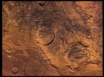 NASA's Viking Orbiter 2 shows Syria Planum-centered volcanism and tectonism produced fractures, narrow to broad grabens, large scarps, and broad fold and thrust ridges that deformed a basement complex.