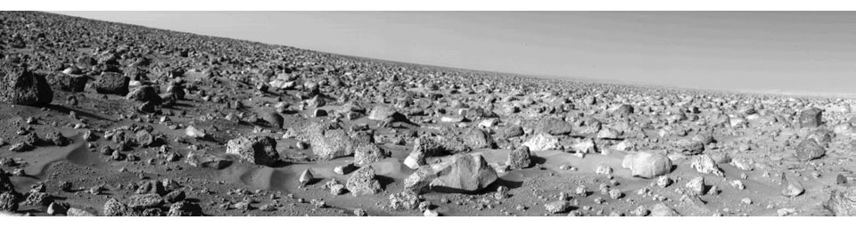 The rocky Martian plain surrounding NASA's Viking 2 is seen in high resolution in this 85-degree panorama sweeping from north at the left to east at right during the Martian afternoon on Sept. 5, 1976.