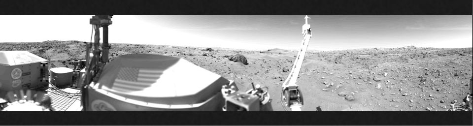 Sand dunes and large rocks are revealed in this panorama picture of Mars, the first photograph taken by NASA's Viking 1's Camera 1 on July 23, 1976. The horizon is approximately 3 kilometers (2 miles) away.